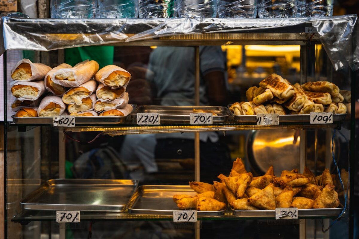 A vibrant display of baked goods and pastries in a street food stall in Colombo, Sri Lanka.